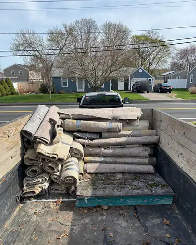 Rolled carpet and padding in the truck bed