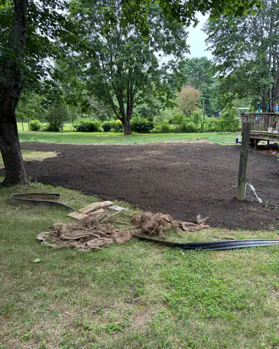 After: graded level and covered in fresh loam