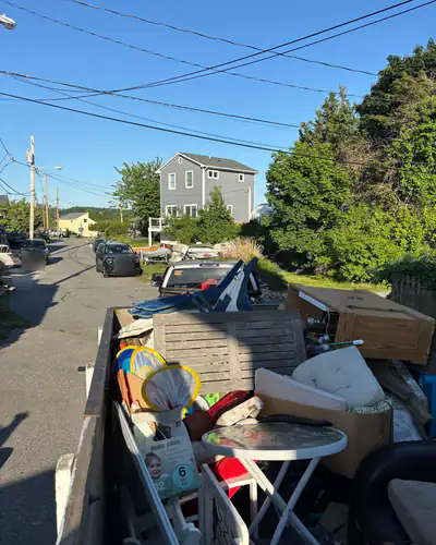 Trailer loaded with patio furniture and boxes
