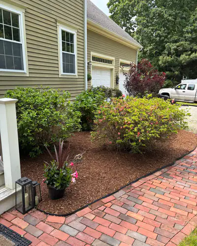 After: bed mulched along the brick walk