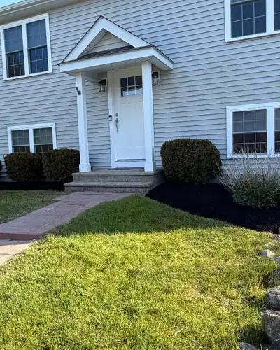 Edged mulch beds along a front walk