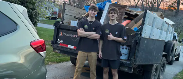 Two of the crew with a full trailer at sunset